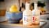 Dve steklenici ekstra deviškega oljčnega olja Brightland z modro skledo limon v ozadju. - Olive Oil Times