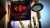 Znak za Carrefour Express z rdečim logotipom in imenom v oranžnem besedilu na črnem ozadju. - Olive Oil Times