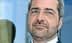 Ein Mann mit Brille und Bart schaut mit neutralem Gesichtsausdruck direkt in die Kamera. - Olive Oil Times