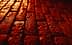 Close-up view of a textured red brick surface with visible imperfections and patterns. - Olive Oil Times