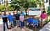 A group of nine individuals posing in front of a sign that reads 'The Garden of Peace'. - Olive Oil Times