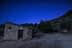 Um edifício de pedra com uma porta de madeira sob um céu estrelado com rastros de meteoros visíveis. - Olive Oil Times