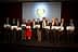 Group of individuals holding awards during a ceremony with a backdrop display. - Olive Oil Times