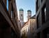 View of the twin towers of Munich's Cathedral framed by surrounding buildings. - Olive Oil Times