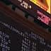 Electronic stock market ticker displaying various indices and their values in a financial setting. - Olive Oil Times