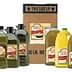 Various bottles of olive oil in different sizes alongside a cardboard box labeled with product information. - Olive Oil Times