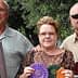 Three individuals posing together, holding various awards and ribbons in their hands. - Olive Oil Times