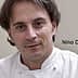Portrait of chef Nino Di Costanzo wearing a white chef's coat and looking directly at the camera. - Olive Oil Times