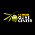 Logo of the UC Davis Olive Center featuring an olive and text in green and yellow. - Olive Oil Times