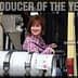 Deborah Rogers sitting on a forklift, labeled '2010 Producer of the Year'. - Olive Oil Times