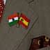 Lapel pins featuring the flags of India and Spain attached to a suit jacket. - Olive Oil Times