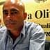 Two men seated at a conference table with a sign that reads 'Terra Olivo'. - Olive Oil Times