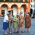 Group of elderly women gathered in a plaza in Córdoba, engaged in conversation. - Olive Oil Times