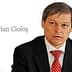 Dacian Cioloș, a man in a suit with a red tie, seated and looking serious. - Olive Oil Times