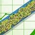 Green and purple olives on a conveyor belt with a green graph background showing upward trends. - Olive Oil Times
