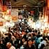 A busy market in Tehran filled with people and various stalls displaying goods. - Olive Oil Times