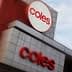 Signage of Coles supermarket featuring the logo and name in red on a building facade. - Olive Oil Times