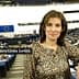 Maria Auxiliadora Correa Zamora posing in the European Parliament chamber with a leopard print top. - Olive Oil Times