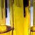 Test tubes containing olive oil samples arranged in a laboratory setting. - Olive Oil Times