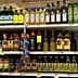 Multiple bottles of olive oil displayed on a grocery store shelf in various sizes and brands. - Olive Oil Times