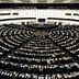 Interior view of the European Parliament with members seated in a circular arrangement. - Olive Oil Times