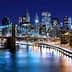 Night view of the Brooklyn Bridge with the Manhattan skyline illuminated in the background. - Olive Oil Times