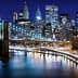 Night view of Brooklyn Bridge with illuminated New York City skyline in the background. - Olive Oil Times