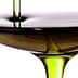 Olive oil being poured into a shallow bowl, showcasing its rich color and texture. - Olive Oil Times