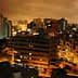 A nighttime view of Lima, Peru, showcasing buildings and city lights under a cloudy sky. - Olive Oil Times
