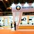 Exhibition booth for Spanish olive oils featuring displays and staff at an event. - Olive Oil Times