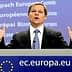A man gesturing while speaking at a podium featuring the European Union logo. - Olive Oil Times