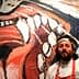 Chef with a beard and white chef's coat standing beside a large colorful mural of a lion's face. - Olive Oil Times
