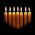 Eight yellow candles arranged in a row, each with a flame, against a dark background. - Olive Oil Times