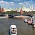 View of the Moscow River with a boat and historical buildings in the background, including the Kremlin. - Olive Oil Times