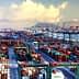 Aerial view of a busy container port filled with cargo containers and cranes. - Olive Oil Times