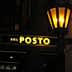 Illuminated sign reading 'Del Posto' with a lantern above it. - Olive Oil Times