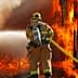 Firefighter in protective gear using a hose to spray water on a large fire. - Olive Oil Times