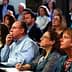 A diverse group of individuals attentively listening during a conference presentation. - Olive Oil Times