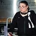 Woman wearing glasses and a black outfit speaking at a podium during an event at the Culinary Institute of America. - Olive Oil Times
