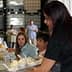 A woman serving ice cream from a tray to attendees at a gathering or event. - Olive Oil Times