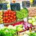 Display of fresh vegetables including tomatoes, green beans, and lettuce at a market stall. - Olive Oil Times