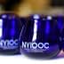 Blue glasses with the NYIOOC logo for the New York International Olive Oil Competition. - Olive Oil Times