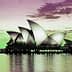 Sydney Opera House with its iconic sail-like structures reflected in the water at dusk. - Olive Oil Times