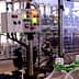 Control panel with buttons and indicators on a bottling machine in a production facility. - Olive Oil Times