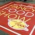 Red carpet with the text 'Winter Fancy Food Show' and 'Specialty Food Association' in yellow and white. - Olive Oil Times