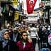 A bustling street in Turkey filled with people walking and shops lining the sides. - Olive Oil Times