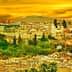 View of the city of Fez, Morocco, with buildings and trees under a yellow sunset sky. - Olive Oil Times