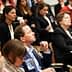 A diverse group of individuals seated in an audience during a conference or seminar event. - Olive Oil Times