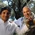 Two chefs posing together, one holding a bottle of yuzu olive oil in an outdoor setting. - Olive Oil Times
