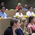 Group of individuals seated in a classroom, attentively listening during a presentation. - Olive Oil Times